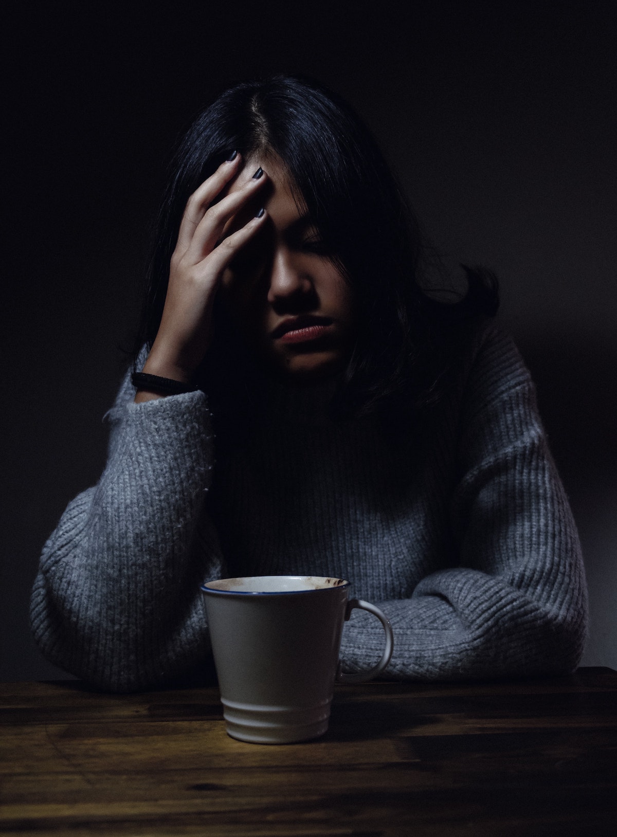 Mental health when working remotely: image of a girl at a table with a cup of coffee