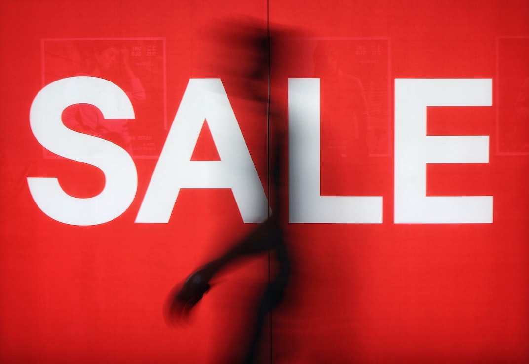 cheap voice overs: man walking past sale sign