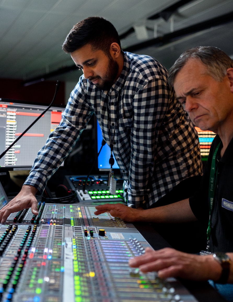 Cheap voice overs: producer and sound engineer at the mixing desk