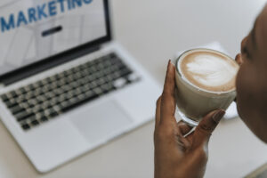 Emotional Marketing Value: image of woman sipping coffee in front of a laptop