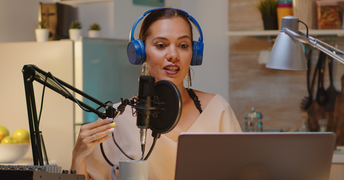 Market your podcast: image of woman podcasting