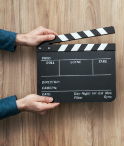 Voice actor: image of assistant holding a clapperboard in front of a camera