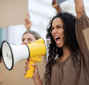 Social audio strategy: woman leading a crowd and using a loughailer