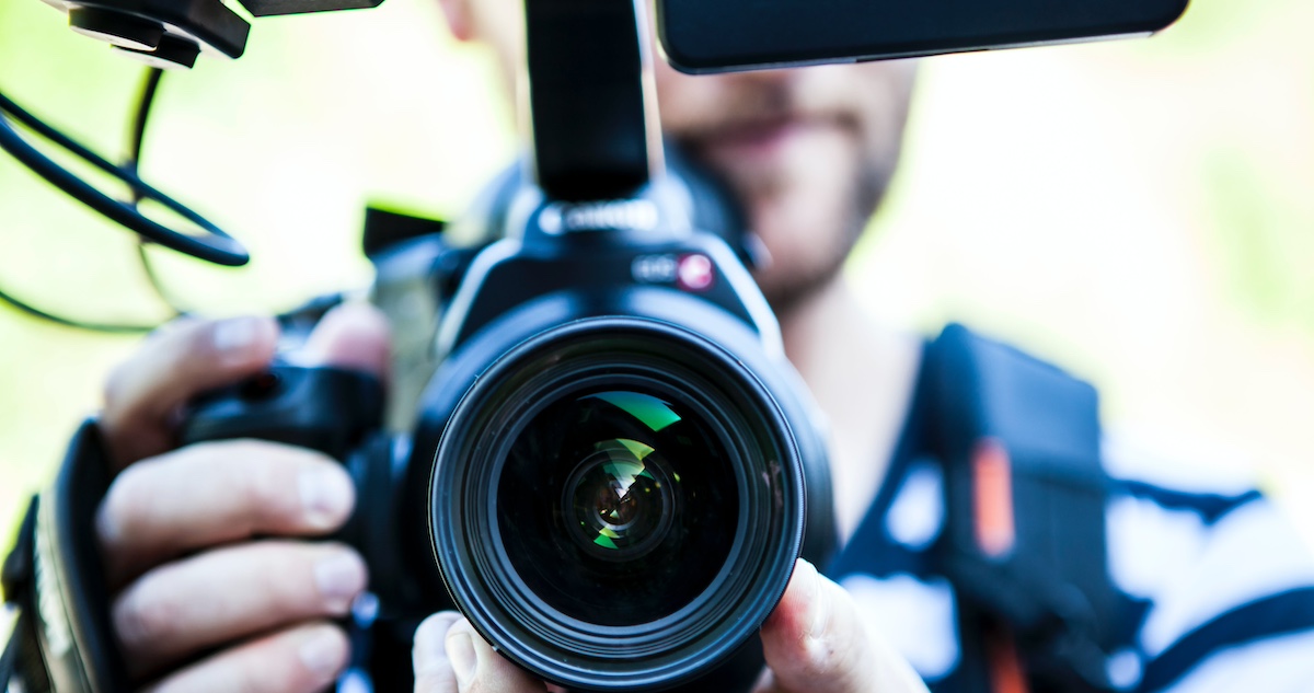 image of a cameraman holding a video camera